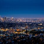 City lights glowing below during blue hour from above