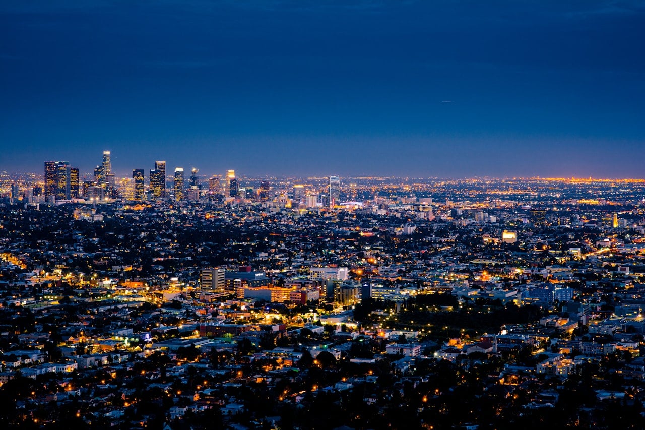 City lights glowing below during blue hour from above
