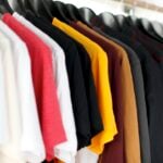 Minimal wardrobe of ten neutral clothing items neatly arranged
