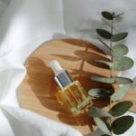 Organic skincare products arranged on marble with green botanical