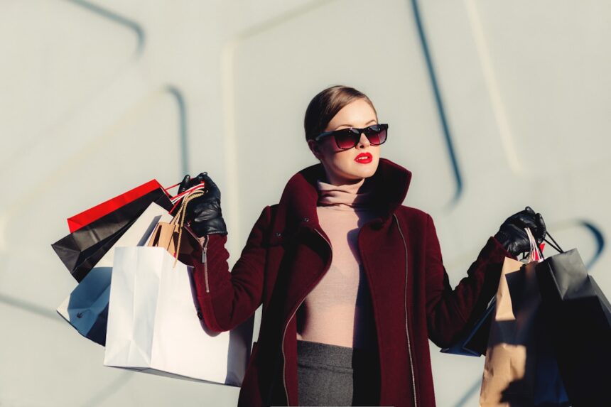 Luxury designer fashion shopping bags on marble floor close