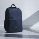 Open travel bag with stadium snacks and comfortable sneakers
