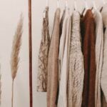 Minimal capsule wardrobe with neutral tones on open rack