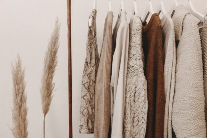 Minimal capsule wardrobe with neutral tones on open rack