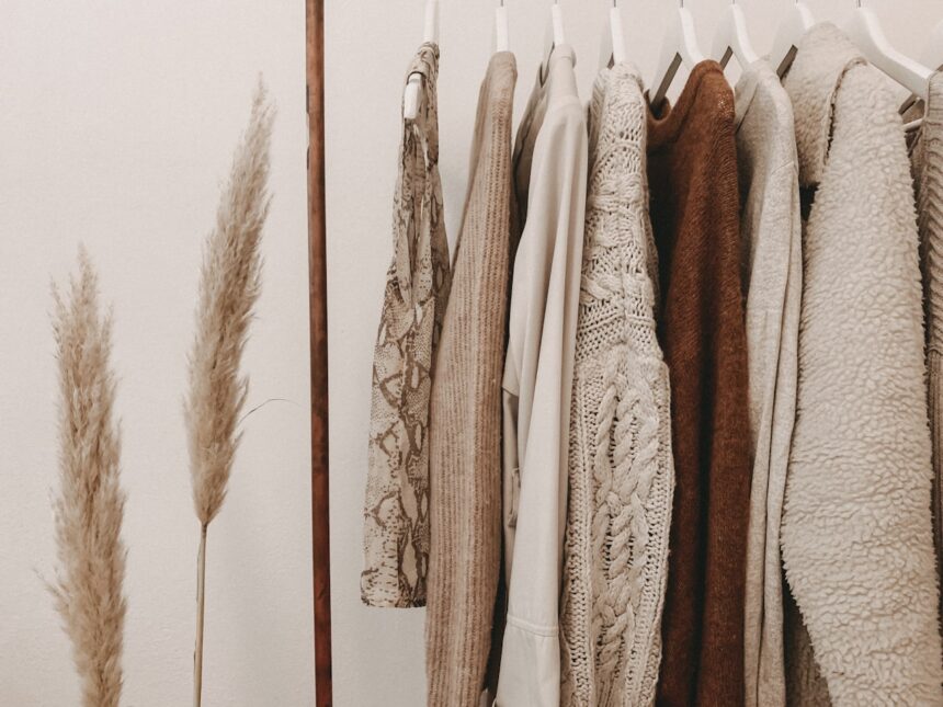 Minimal capsule wardrobe with neutral tones on open rack