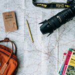 Travel passport documents map and camera on wooden table