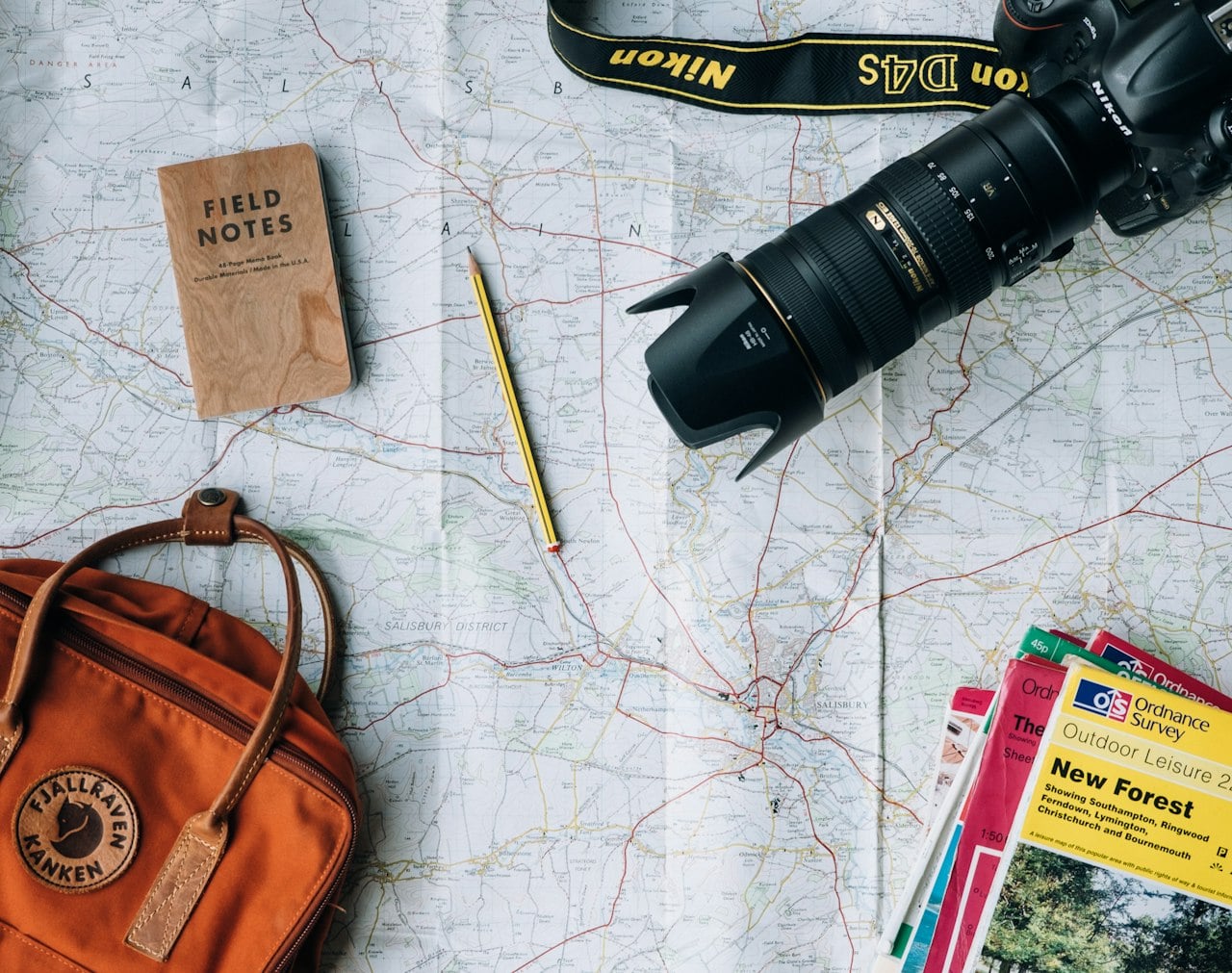 Travel passport documents map and camera on wooden table