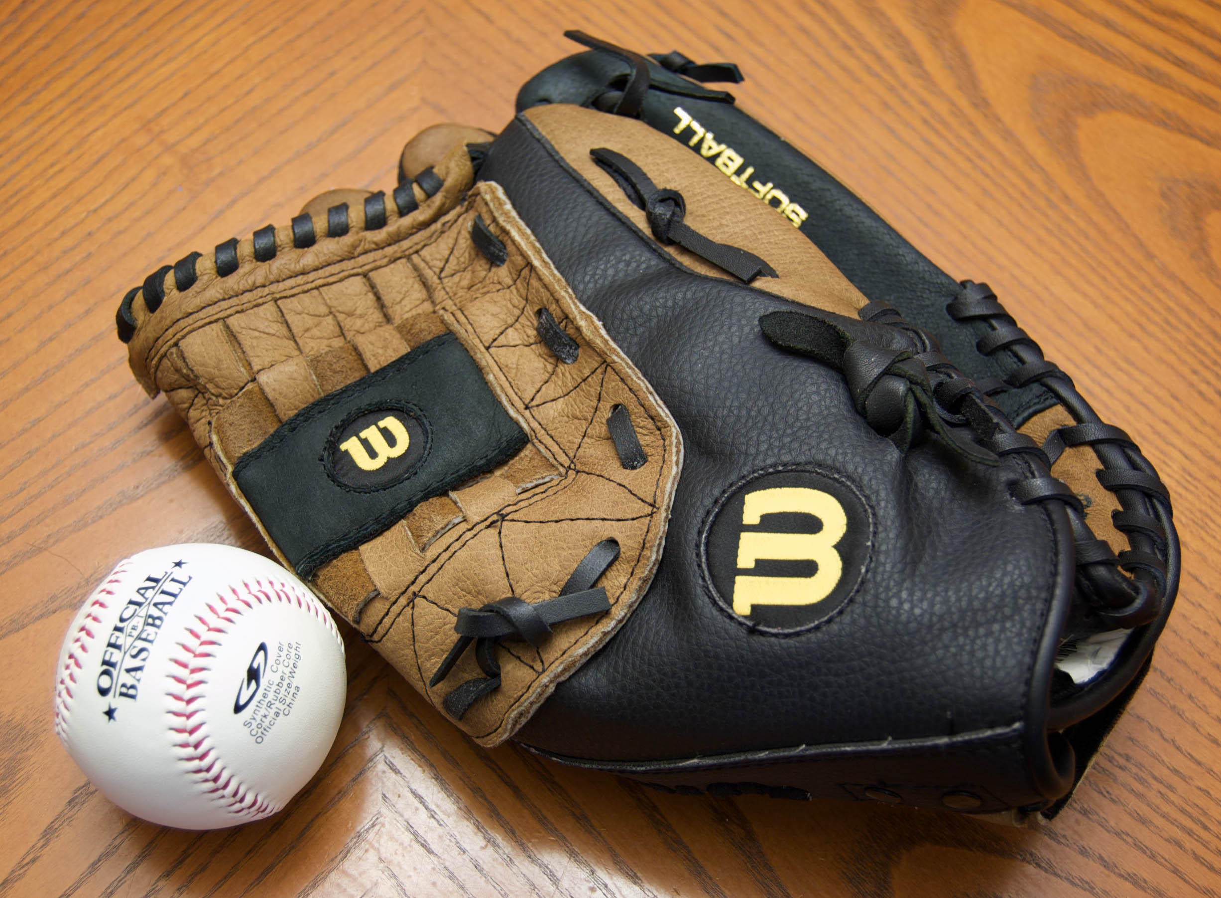 Baseball equipment including wooden bats, a fielding glove and a ball