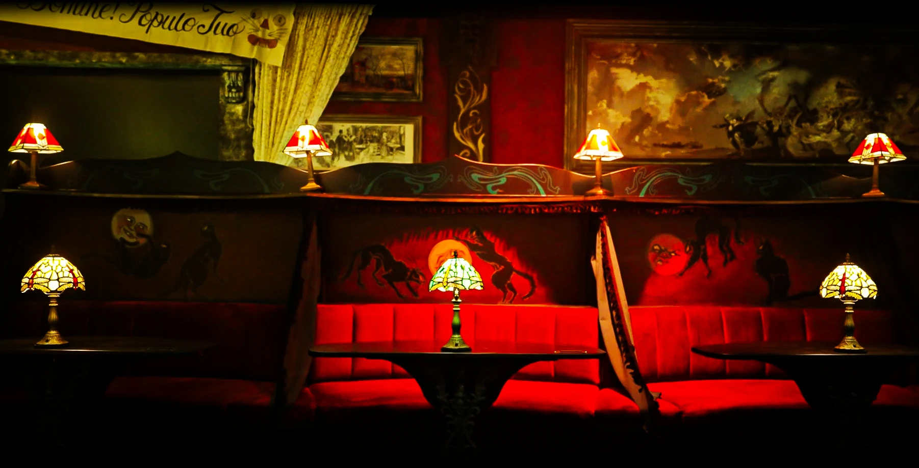 Chat Noir immersive cabaret venue interior with velvet drapes and candlelit tables in West Kensington London