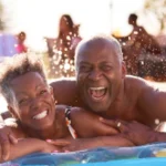 Couple in a pool enjoying a worry-free insured holiday
