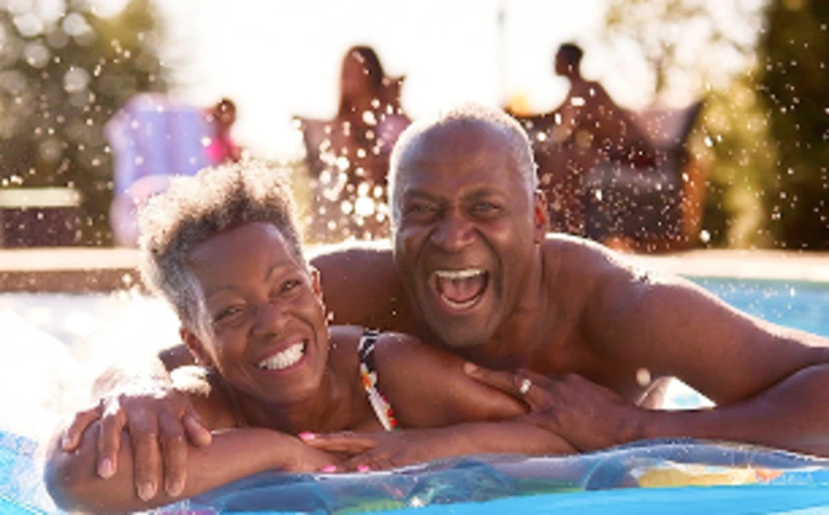 Couple in a pool enjoying a worry-free insured holiday
