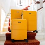 Yellow Journeylife suitcase set on stairs