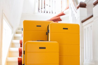 Yellow Journeylife suitcase set on stairs