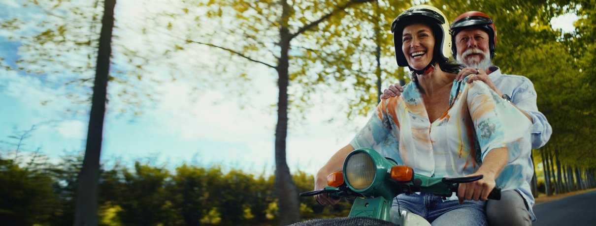 Couple on a moped enjoying travel abroad with Staysure travel insurance cover