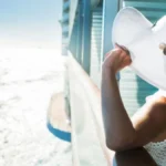 Woman on a cruise ship looking out to sea