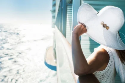 Woman on a cruise ship looking out to sea