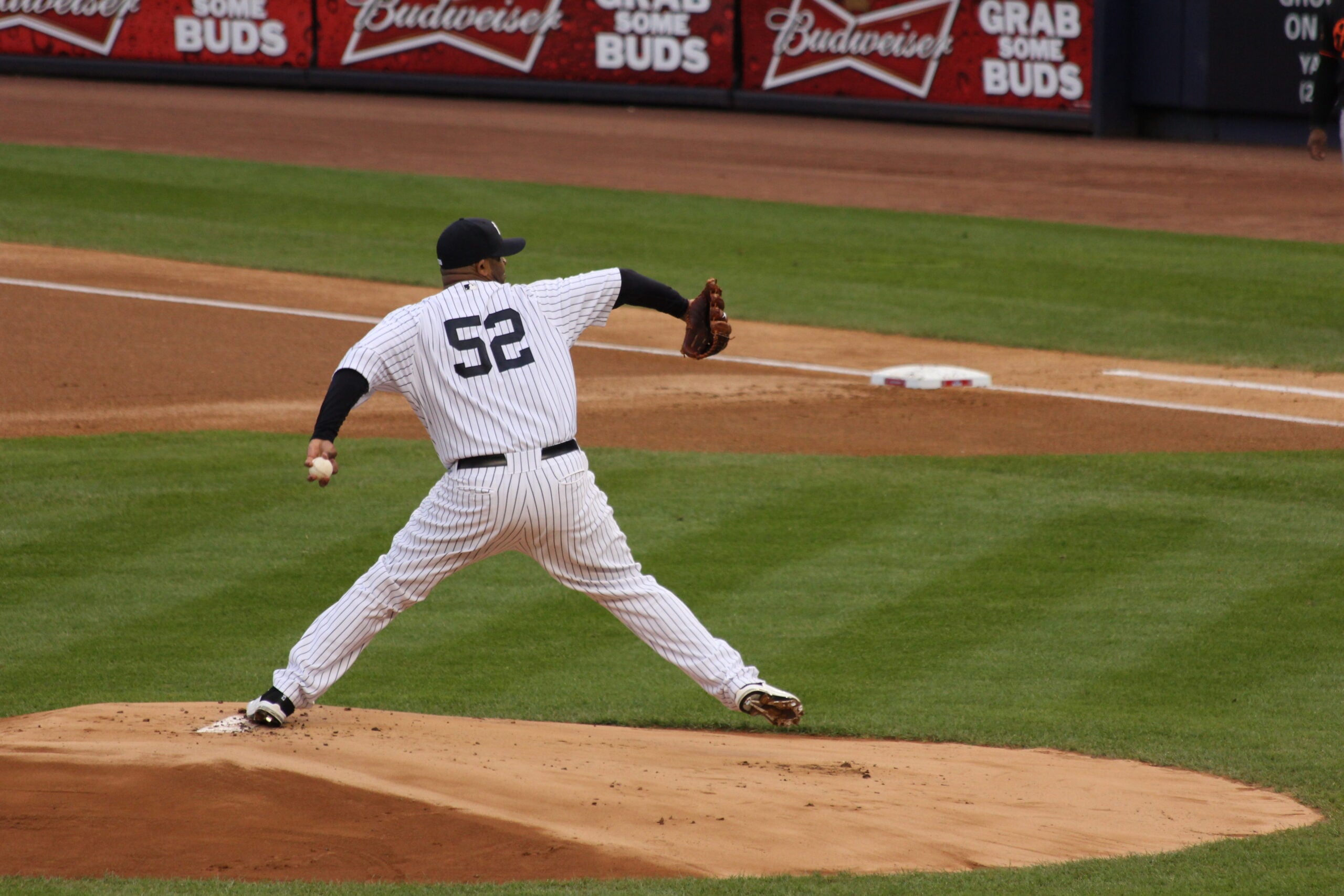 A New York Yankees pitcher delivering a pitch in pinstripes during a big game
