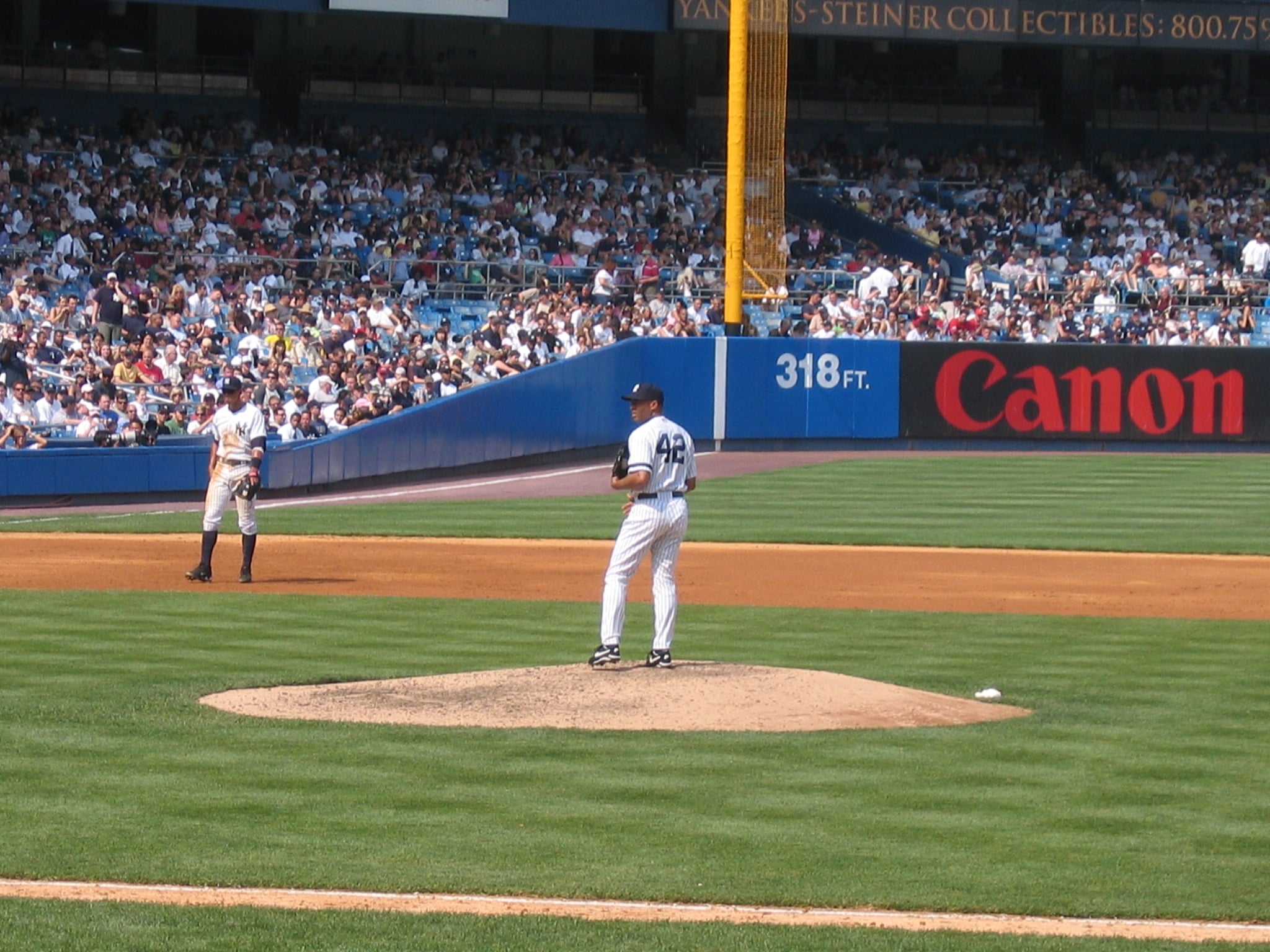 A New York Yankees pitcher winding up on the mound at Yankee Stadium