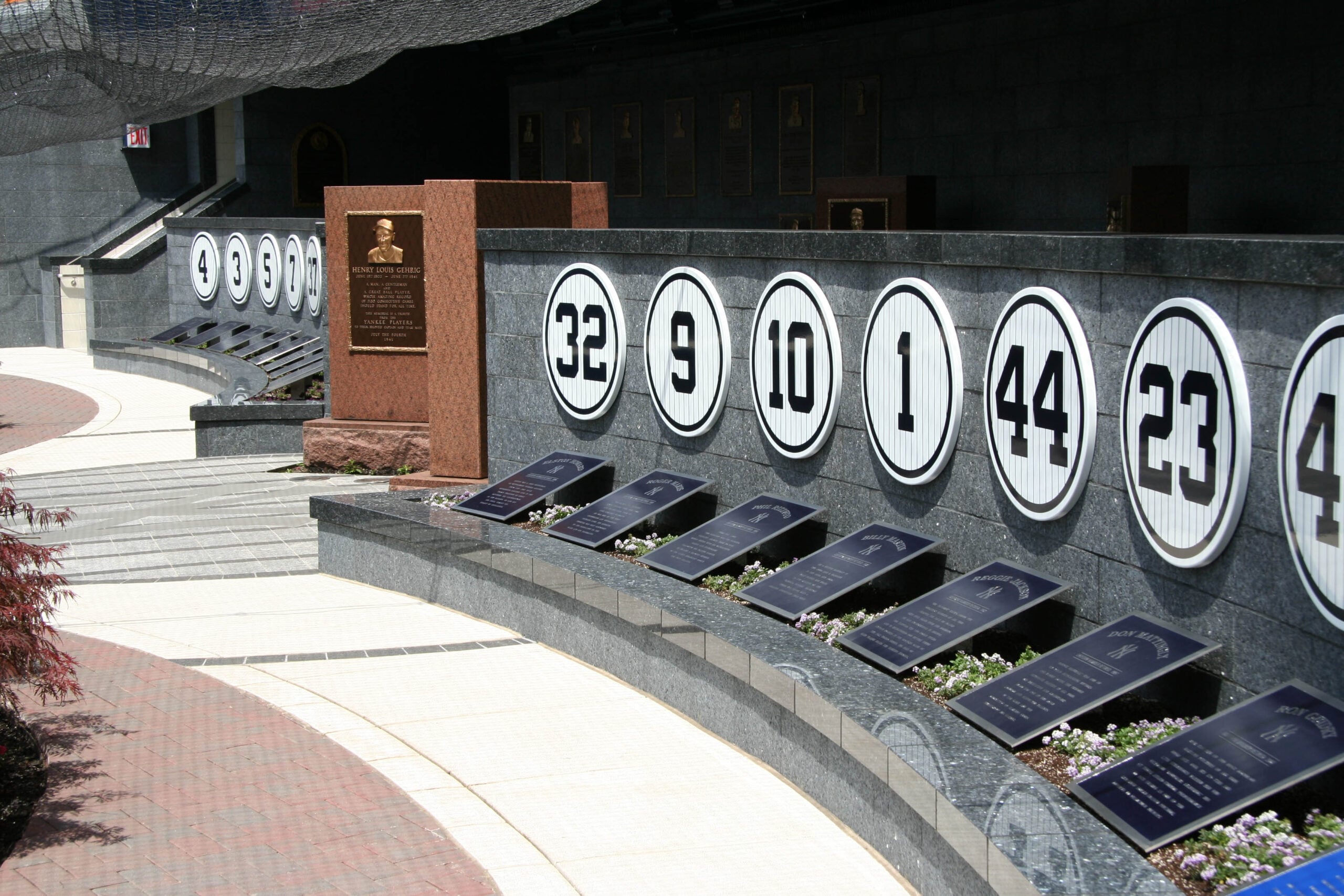 The wall of retired numbers and bronze plaques honoring Yankees greats in Monument Park