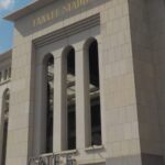 The exterior facade of Yankee Stadium in the Bronx on a summer day