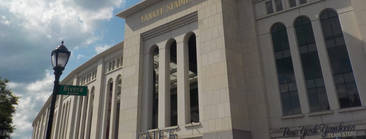 The exterior facade of Yankee Stadium in the Bronx on a summer day