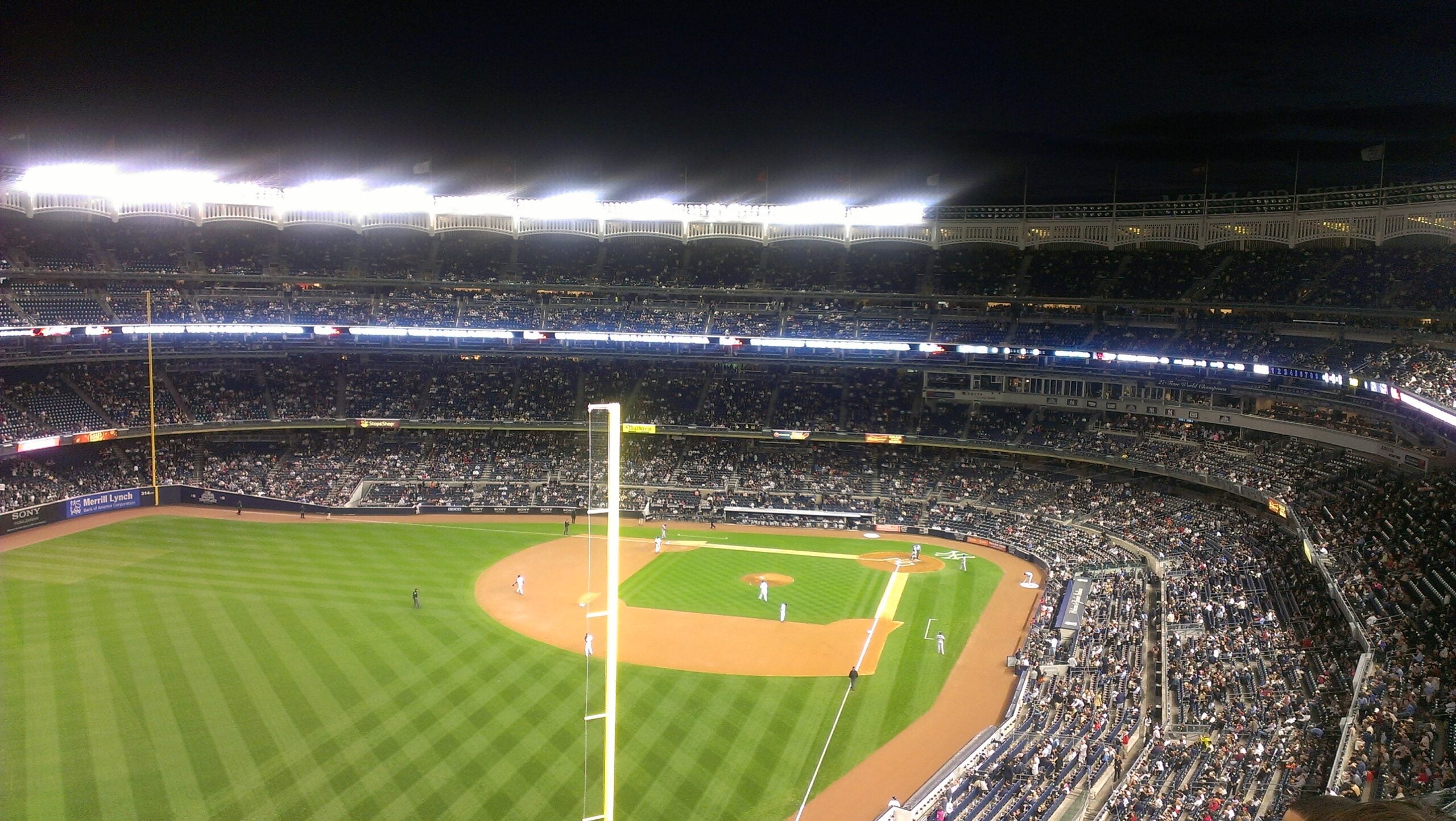 Wide interior view of Yankee Stadium showing the green field and packed seating bowl