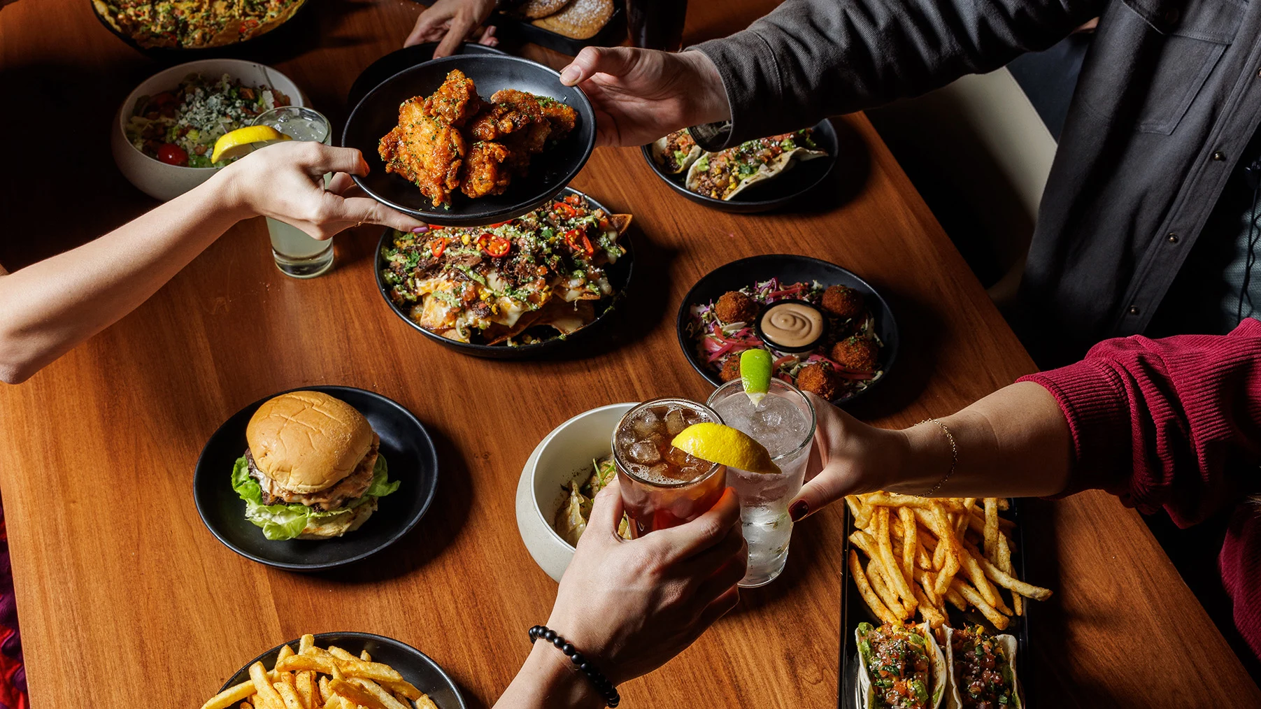 A spread of dishes and cocktails from the menu at Cosm