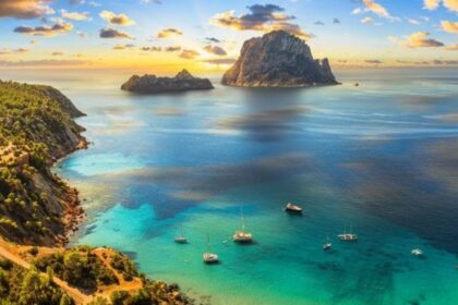 Cala d'Hort bay with Es Vedrà rock, Ibiza - Mediterranean ferry routes with Ferryhopper