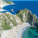 Sunlit UK coastal holiday scene for summer travel insurance