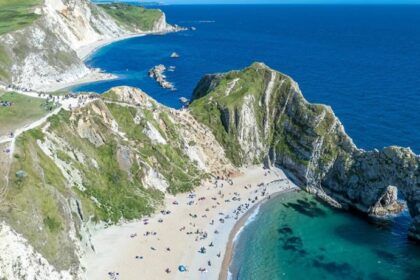 Sunlit UK coastal holiday scene for summer travel insurance