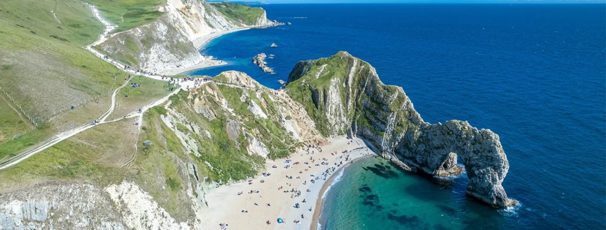 Sunlit UK coastal holiday scene for summer travel insurance