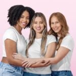 Three women embracing in a bright Happy V wellness lifestyle photograph