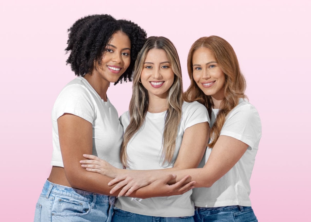 Three women embracing in a bright Happy V wellness lifestyle photograph