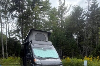 Camper van in a forest campsite