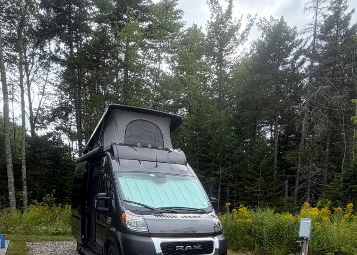 Camper van in a forest campsite