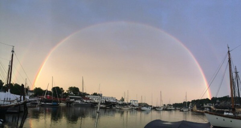 A rainbow over boats at a coastal Host location