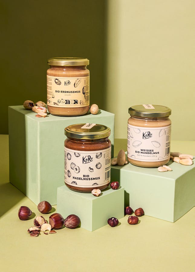 Drei Gläser Bio Nussmus Trio Classic auf grünen Würfeln