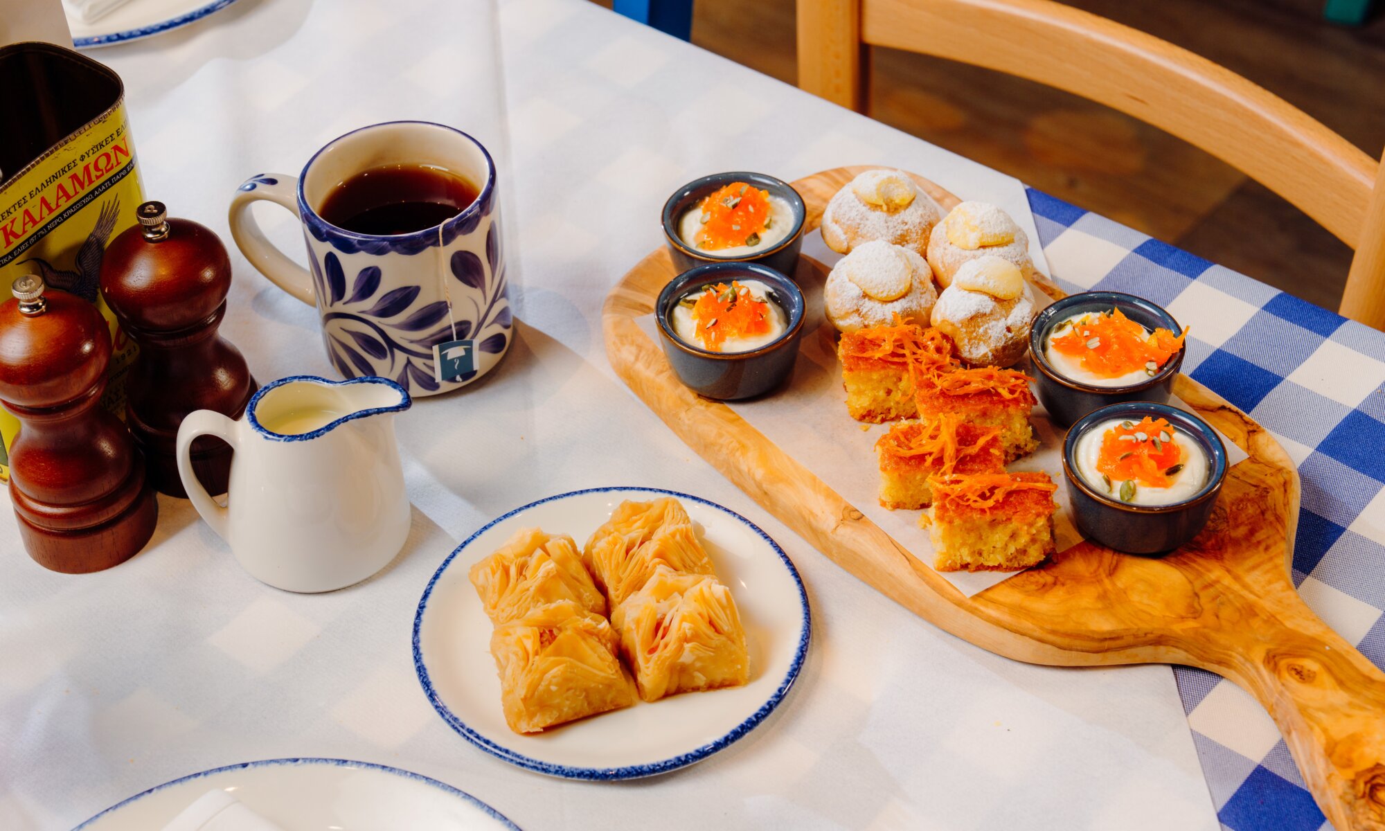 Greek dessert trio with baklava, ravani cake and yoghurt pots served with tea