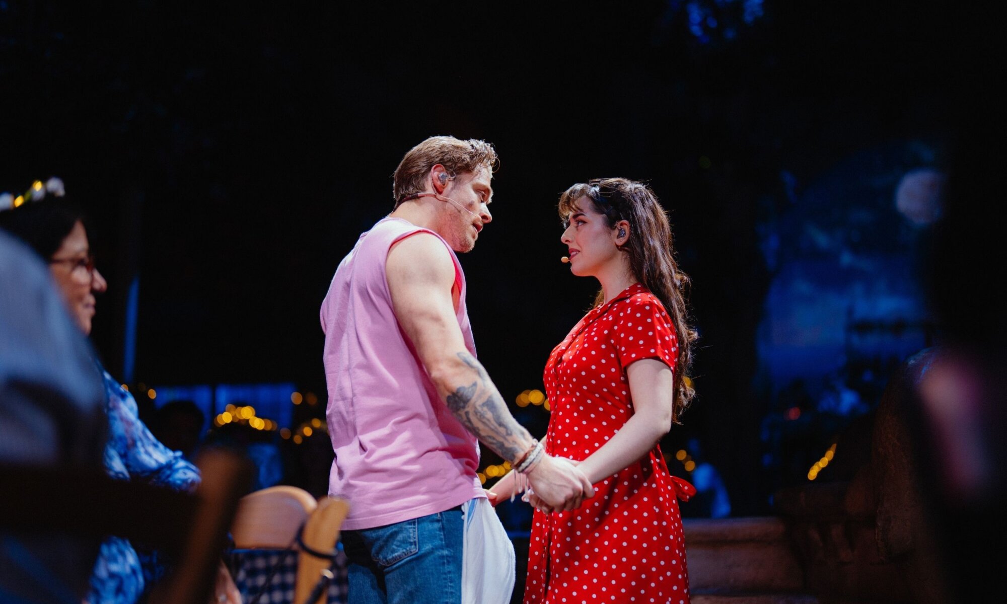 Two performers in an intimate scene during the Mamma Mia! The Party story