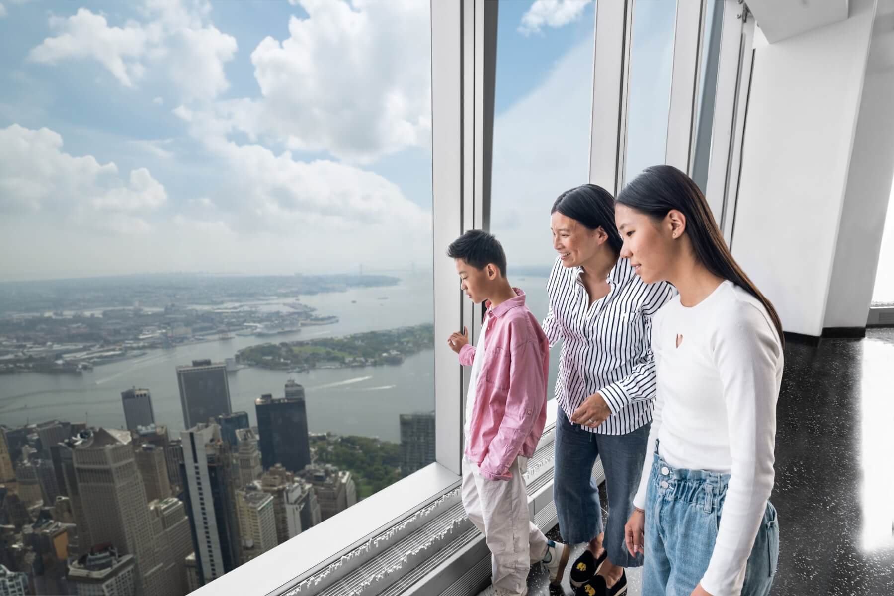 Family taking in the New York view from One World Observatory
