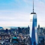Wide aerial view of One World Trade Center and Lower Manhattan from above