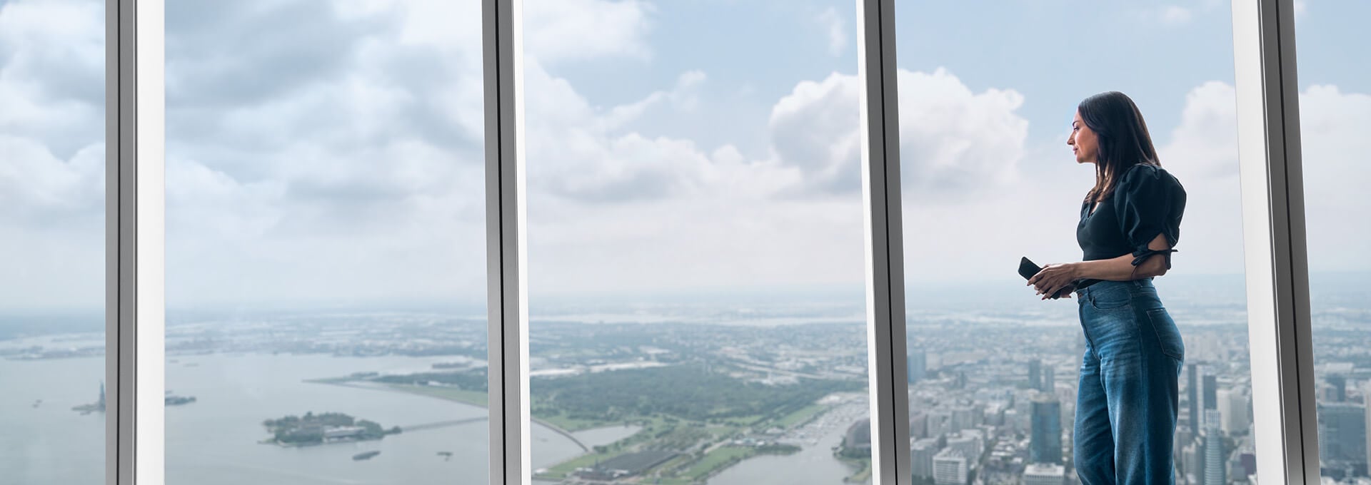 Woman looking through a window at an observatory view
