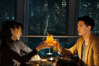Guests dining with the New York skyline at One World Observatory