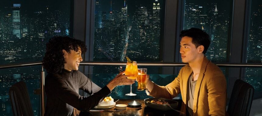 Guests dining with the New York skyline at One World Observatory