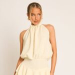 Cream textured flippy playsuit styled on a model for Rebellious Fashion
