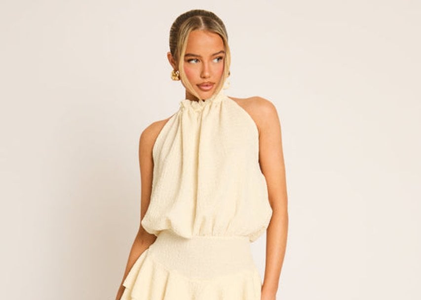 Cream textured flippy playsuit styled on a model for Rebellious Fashion
