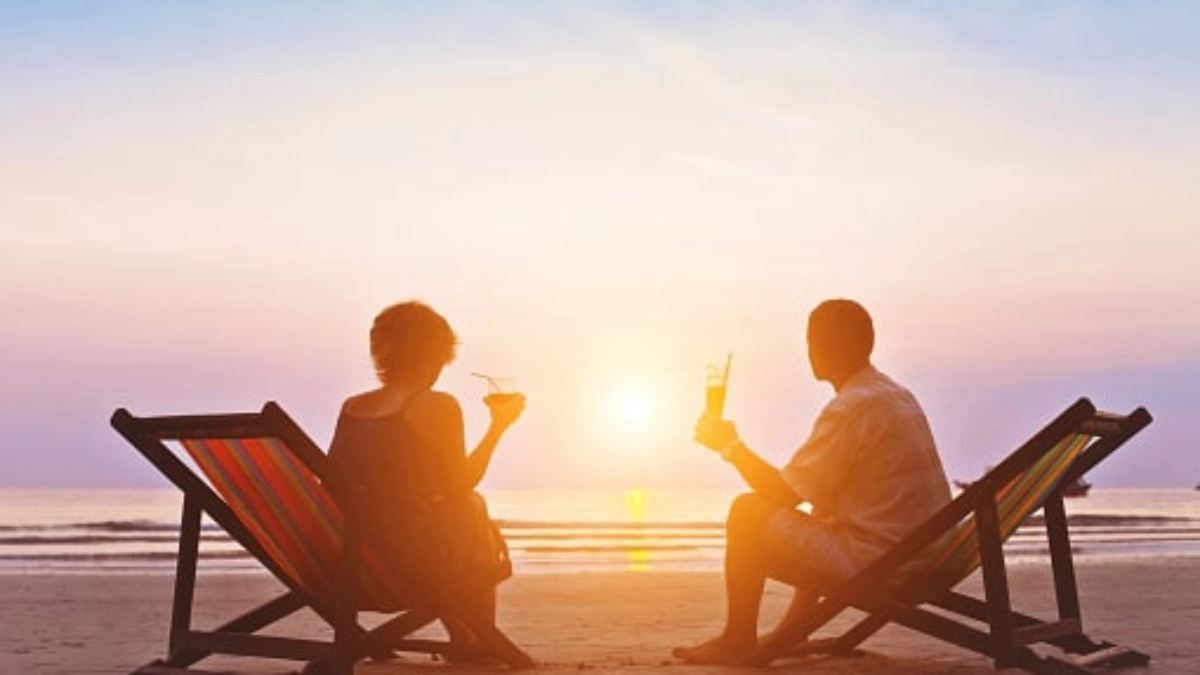 Couple relaxing in beach deckchairs