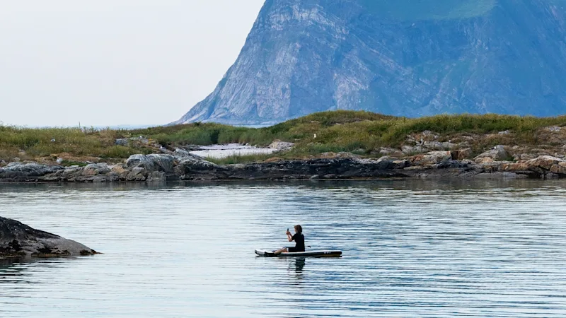Kayaker exploring a Nordic landscape