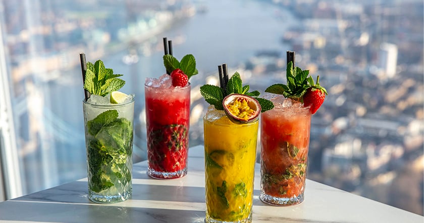 Colorful cocktails beside a London city view
