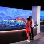 Visitors enjoying the indoor observation deck with Boston skyline views